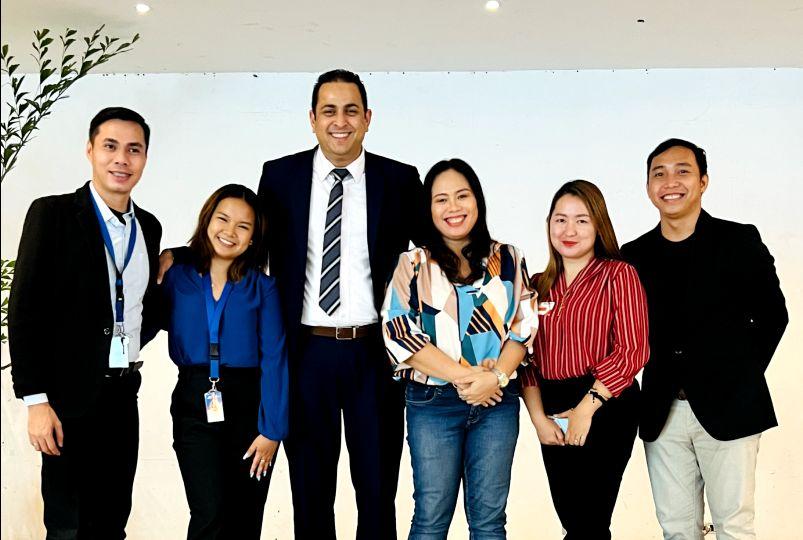 MaxiMax staff standing together at an event