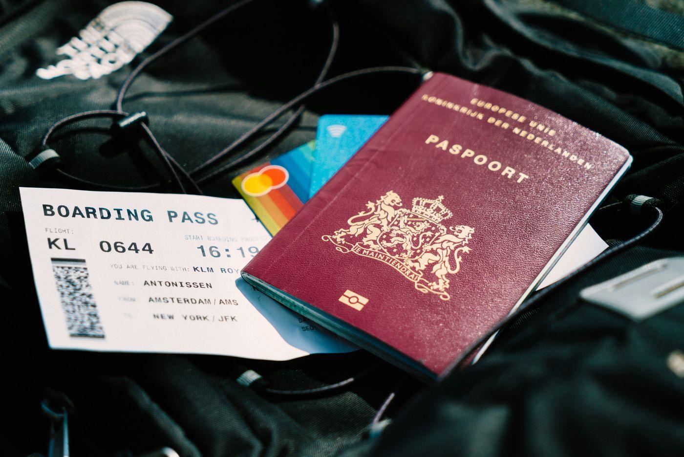 A passport and a boarding pass resting on a bag