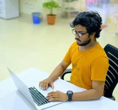 A young professional working on a laptop